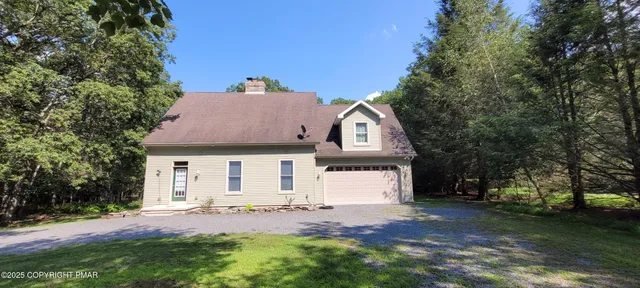 a view of a house with swimming pool and sitting area