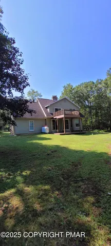 an aerial view of residential house with an outdoor space and seating area