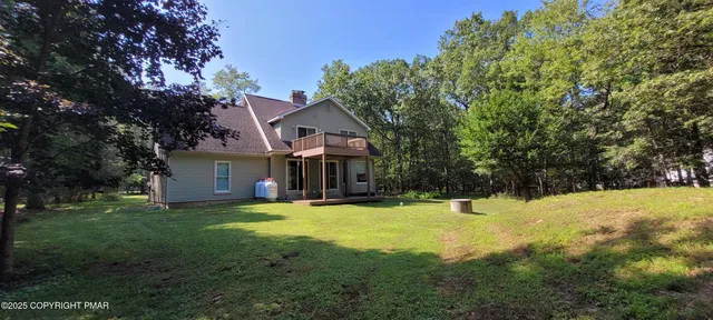 an aerial view of residential house with pool and yard