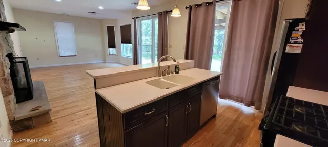 a kitchen with stainless steel appliances granite countertop a refrigerator and a stove top oven