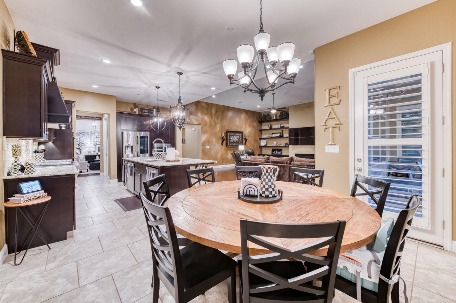 1967 Powers Avenue Clovis, CA 93619 - Photo 14 of 71 a view of a dining room with furniture a chandelier and wooden floor