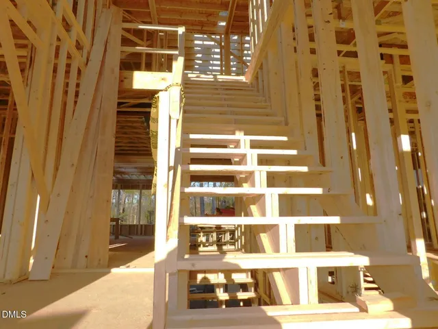 a black and white photo of a bench in a bathroom