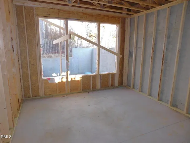 a view of a dining room with furniture large windows and outdoor view