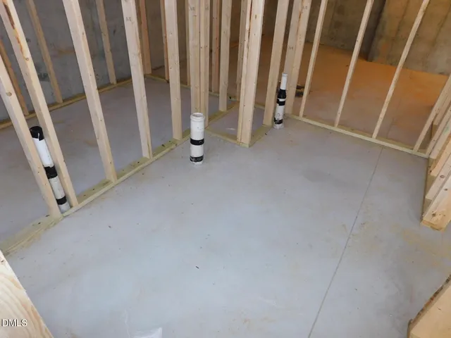 a dining room with wooden floor and large windows