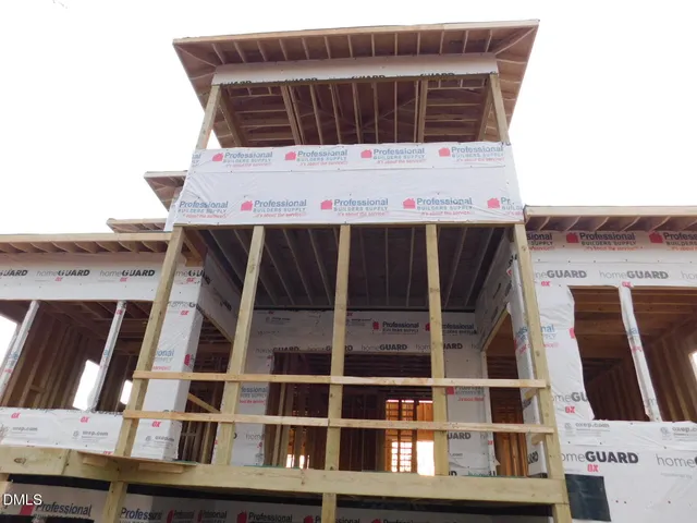 a bedroom with a bed and a lamp on dresser