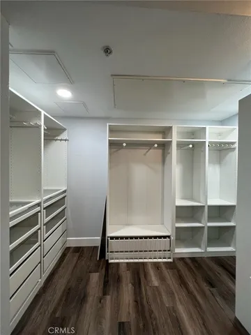 a living room with a wooden floor and furniture