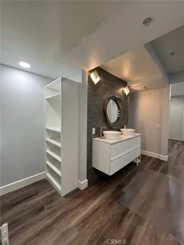 a bathroom with a tub sink and mirror