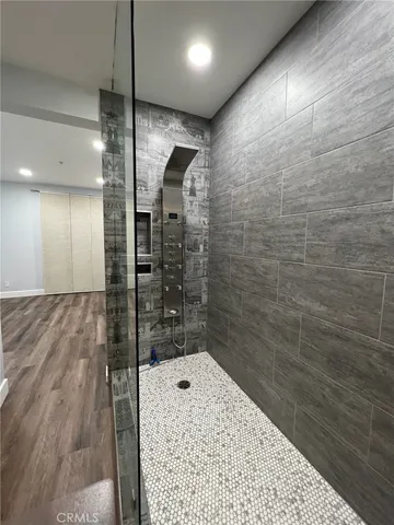 a bathroom with a bathtub and shower