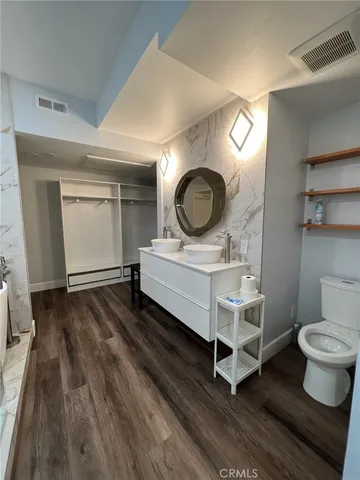 a hallway with chairs a washer and dryer