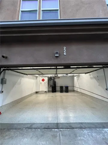 an empty room with windows and cabinet