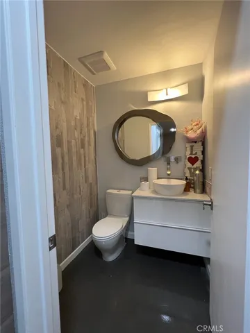 a large kitchen with stainless steel appliances a large counter top a stove a chimney a sink and a refrigerator