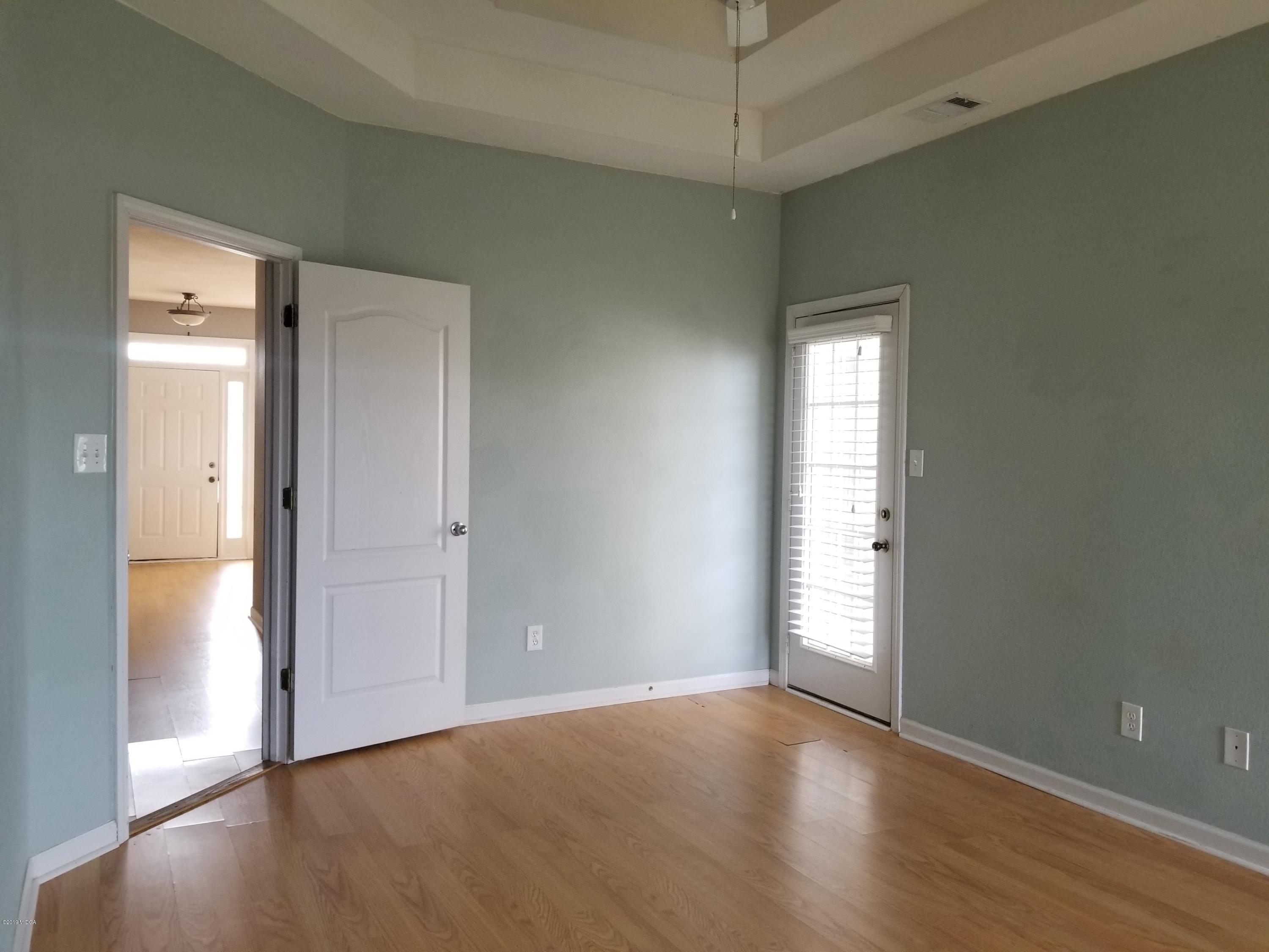 425 Bob White Road Macon, GA 31216 - Photo 13 of 20 an empty room with wooden floor and windows