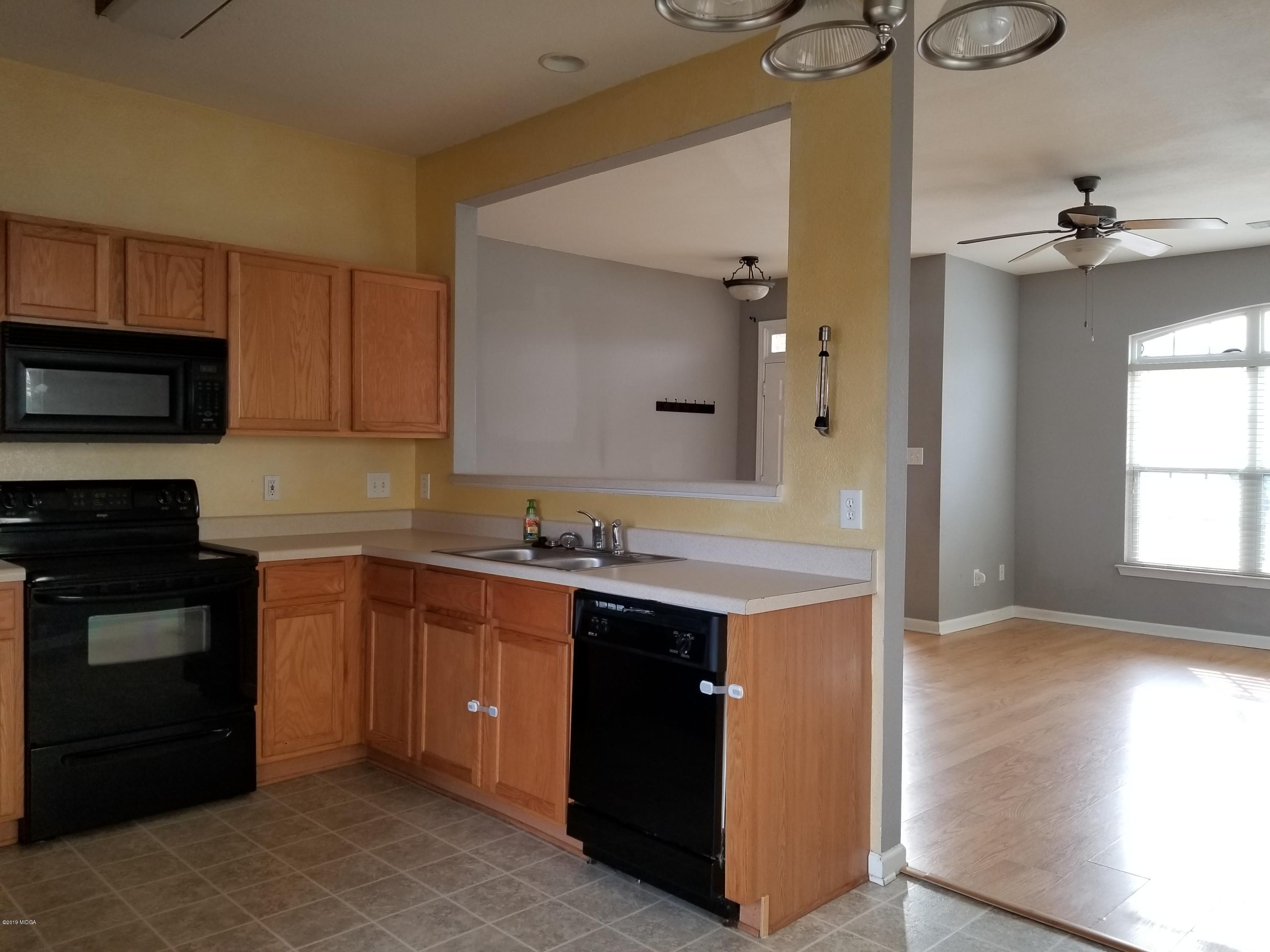 425 Bob White Road Macon, GA 31216 - Photo 6 of 20 a kitchen with a sink and a stove top oven