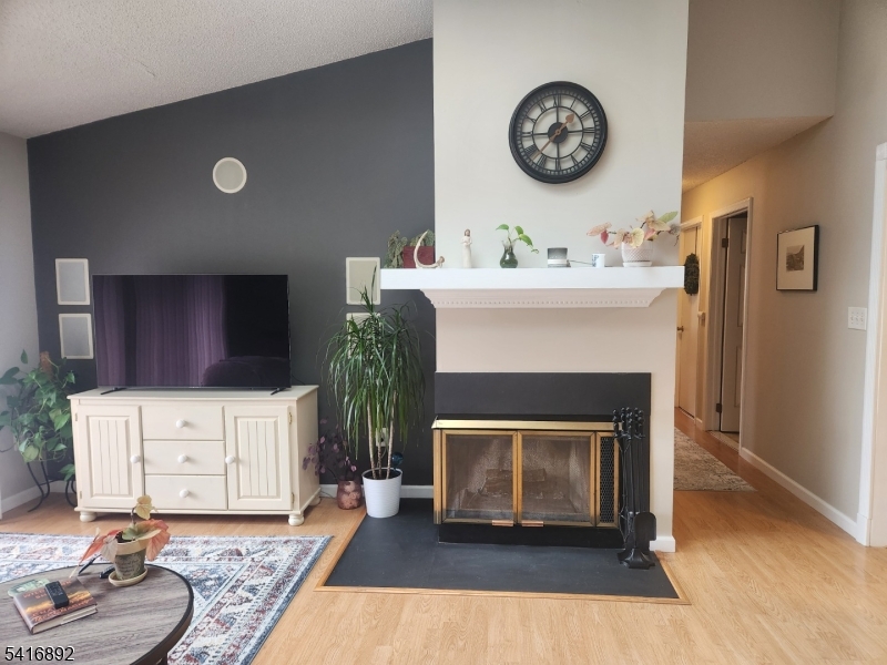 a living room with furniture a clock and a fireplace