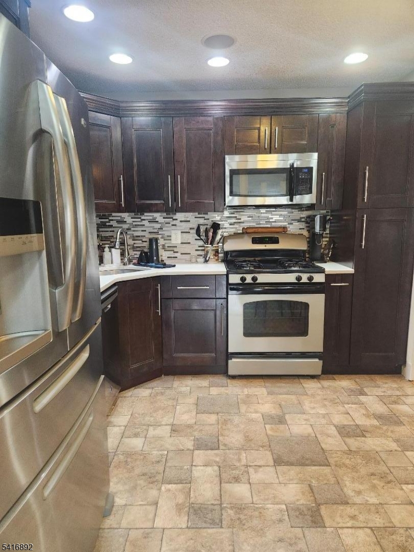 330 Penns Way Bernards, NJ 07920 - Photo 5 of 13 a kitchen with stainless steel appliances granite countertop a stove a sink and a refrigerator