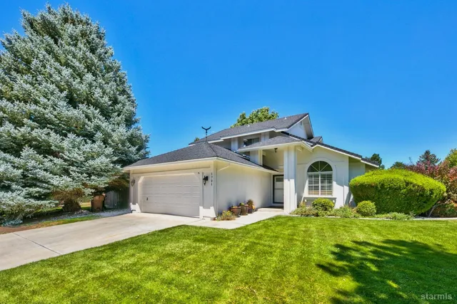 a view of a house with a yard and garage