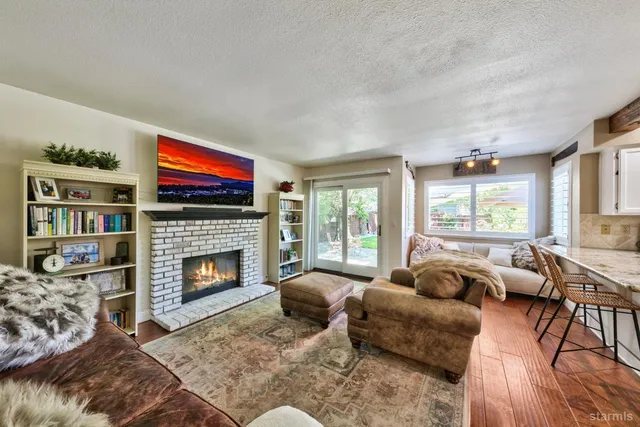 a living room with furniture flat screen tv and a fireplace