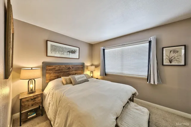 a bedroom with a bed and a night stand