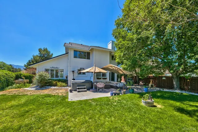 a front view of a house with garden and a patio
