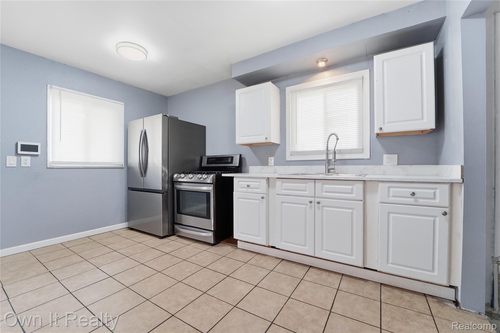26772 Colgate Street Inkster, MI 48141 - Photo 8 of 25 Kitchen featuring tile flooring, white cabinetry, stainless steel appliances, and a window with blinds