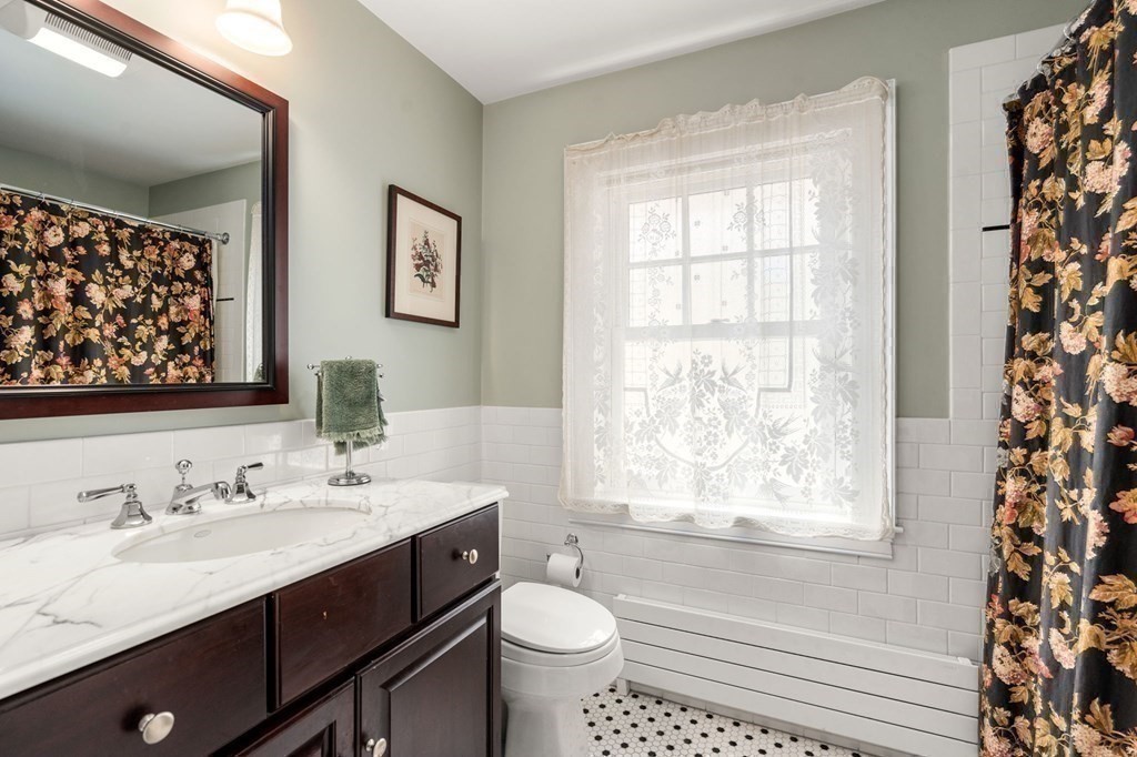 78 Addington Road Brookline, MA 02445 - Photo 21 of 30 a bathroom with a double vanity sink toilet and a window