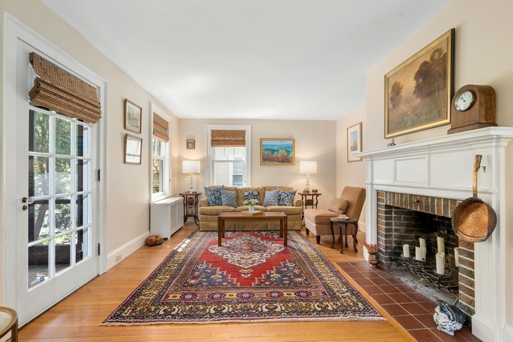 78 Addington Road Brookline, MA 02445 - Photo 8 of 30 a living room with furniture a rug a fireplace and windows