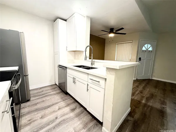 a kitchen with a sink stove and cabinets
