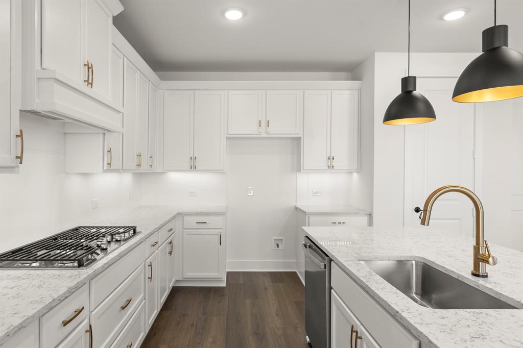 4100 Explorer Way McKinney, TX 75071 - Photo 13 of 27 a kitchen with a sink a stove and cabinets