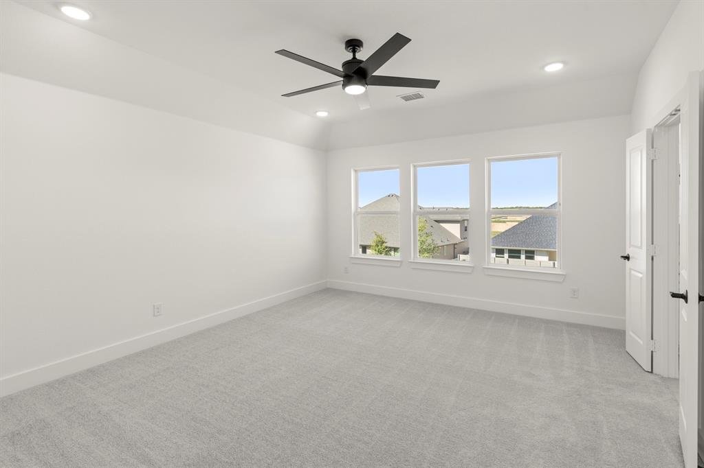 4100 Explorer Way McKinney, TX 75071 - Photo 14 of 27 an empty room with windows and fan