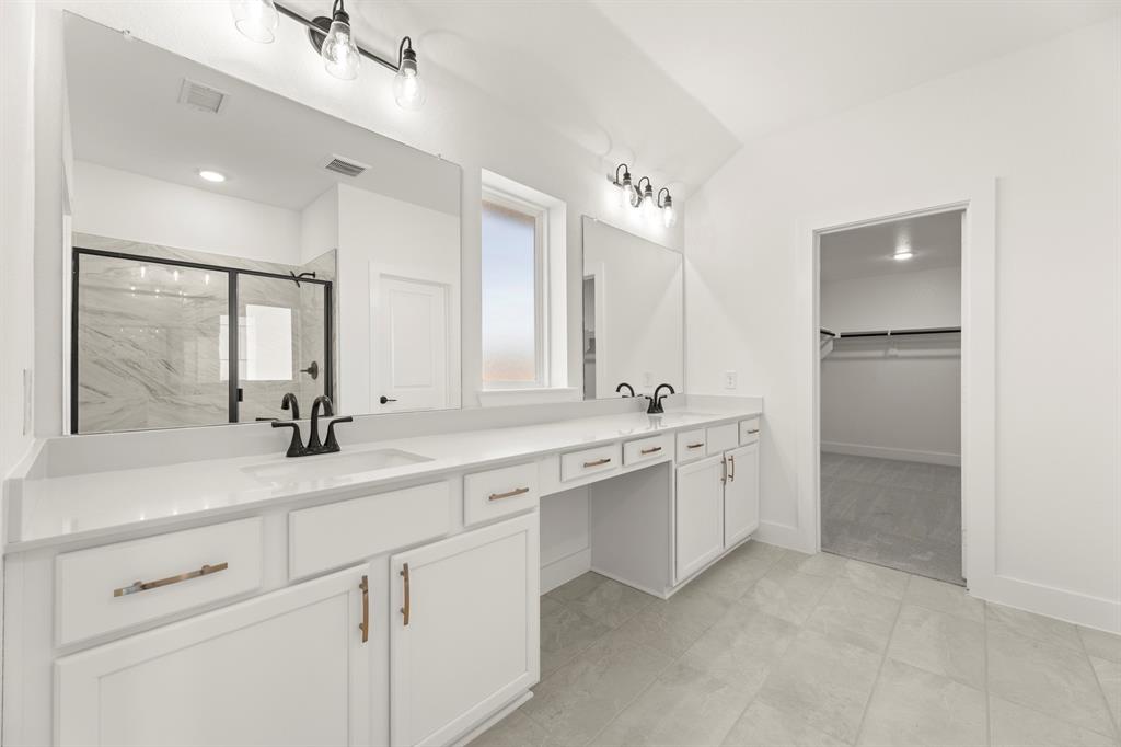 4100 Explorer Way McKinney, TX 75071 - Photo 17 of 27 a spacious bathroom with a shower sink and mirror