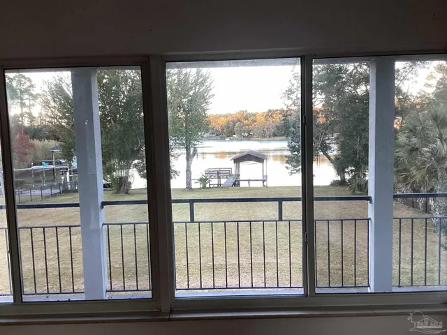 a view of a glass door with a trees from a window