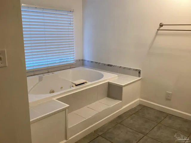 a bathroom with a tub and a window