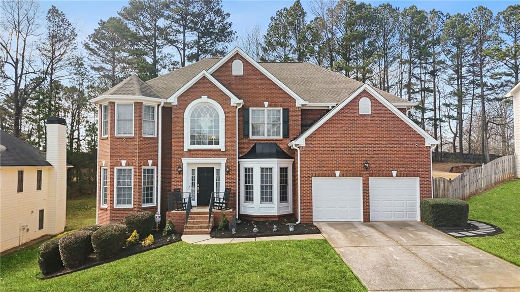 1203 Big Tree Pointe Villa Rica, GA 30180 - Photo 1 of 42 a front view of a house with a yard