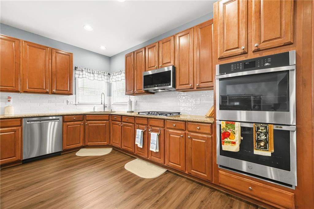 1203 Big Tree Pointe Villa Rica, GA 30180 - Photo 14 of 42 a kitchen with stainless steel appliances granite countertop a stove a sink and a microwave