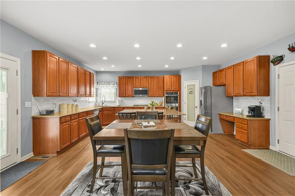 1203 Big Tree Pointe Villa Rica, GA 30180 - Photo 18 of 42 a kitchen with a table chairs microwave and cabinets