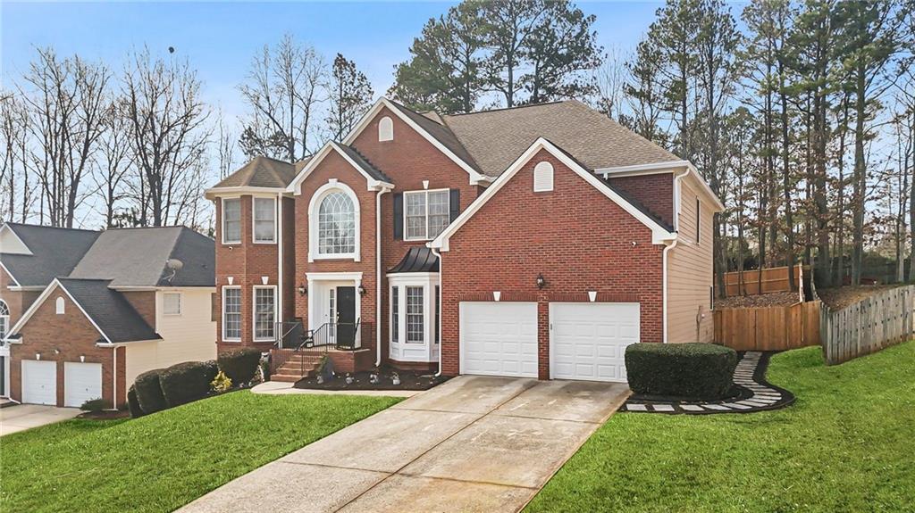 1203 Big Tree Pointe Villa Rica, GA 30180 - Photo 2 of 42 a front view of a house with a yard