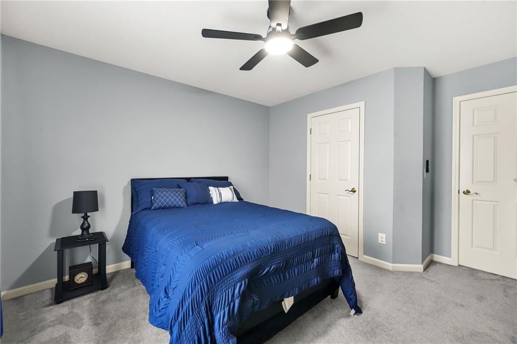 1203 Big Tree Pointe Villa Rica, GA 30180 - Photo 22 of 42 a bedroom with a bed and a chandelier