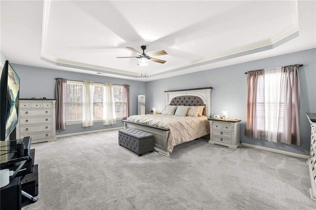 1203 Big Tree Pointe Villa Rica, GA 30180 - Photo 24 of 42 a bedroom with a bed and a chandelier