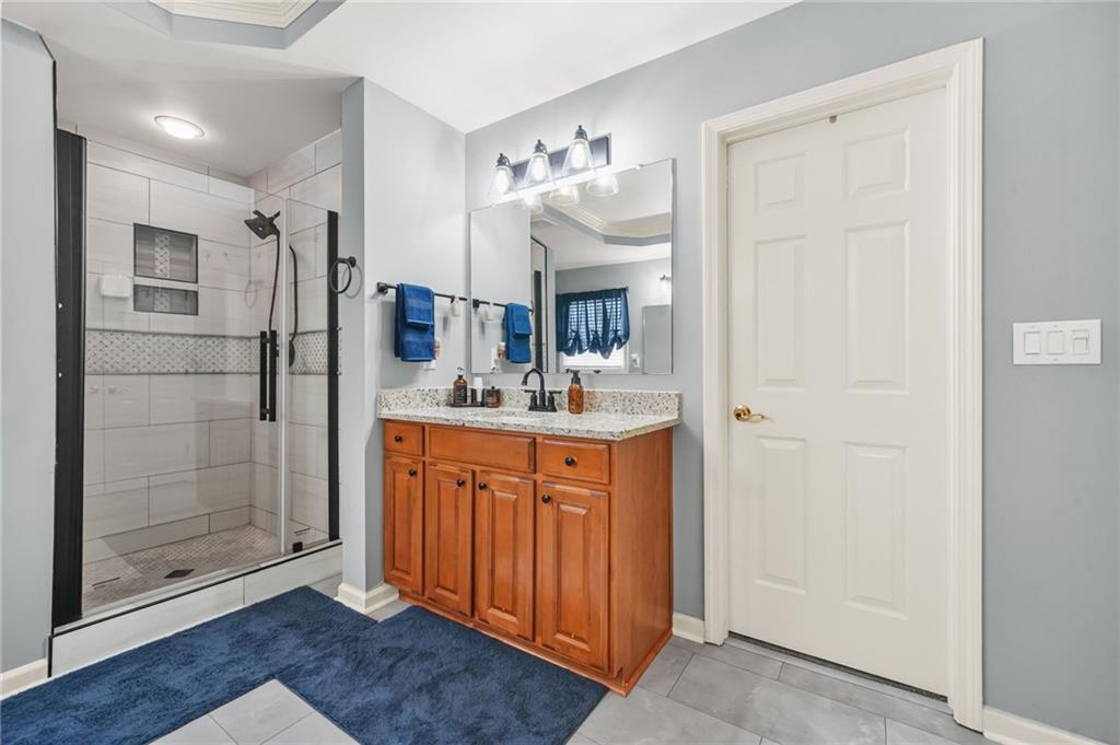 1203 Big Tree Pointe Villa Rica, GA 30180 - Photo 28 of 42 a bathroom with a shower sink and mirror