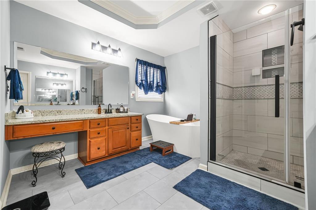 1203 Big Tree Pointe Villa Rica, GA 30180 - Photo 29 of 42 a bathroom with a sink double vanity and a shower