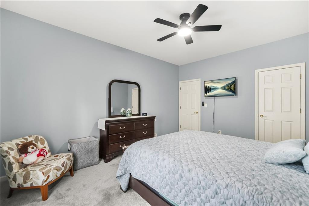1203 Big Tree Pointe Villa Rica, GA 30180 - Photo 30 of 42 a bedroom with a bed and a chandelier