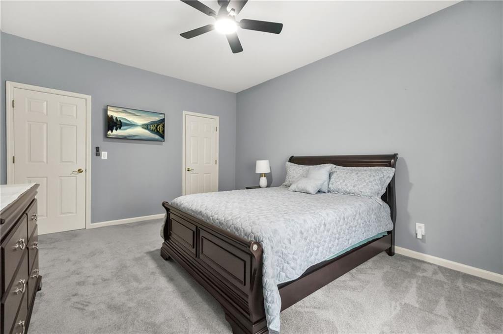 1203 Big Tree Pointe Villa Rica, GA 30180 - Photo 31 of 42 a bedroom with a bed and a chandelier