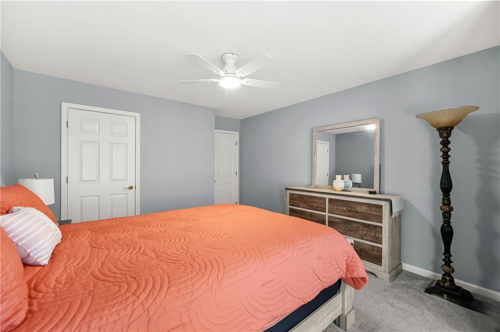 1203 Big Tree Pointe Villa Rica, GA 30180 - Photo 34 of 42 a bedroom with a bed and a chandelier