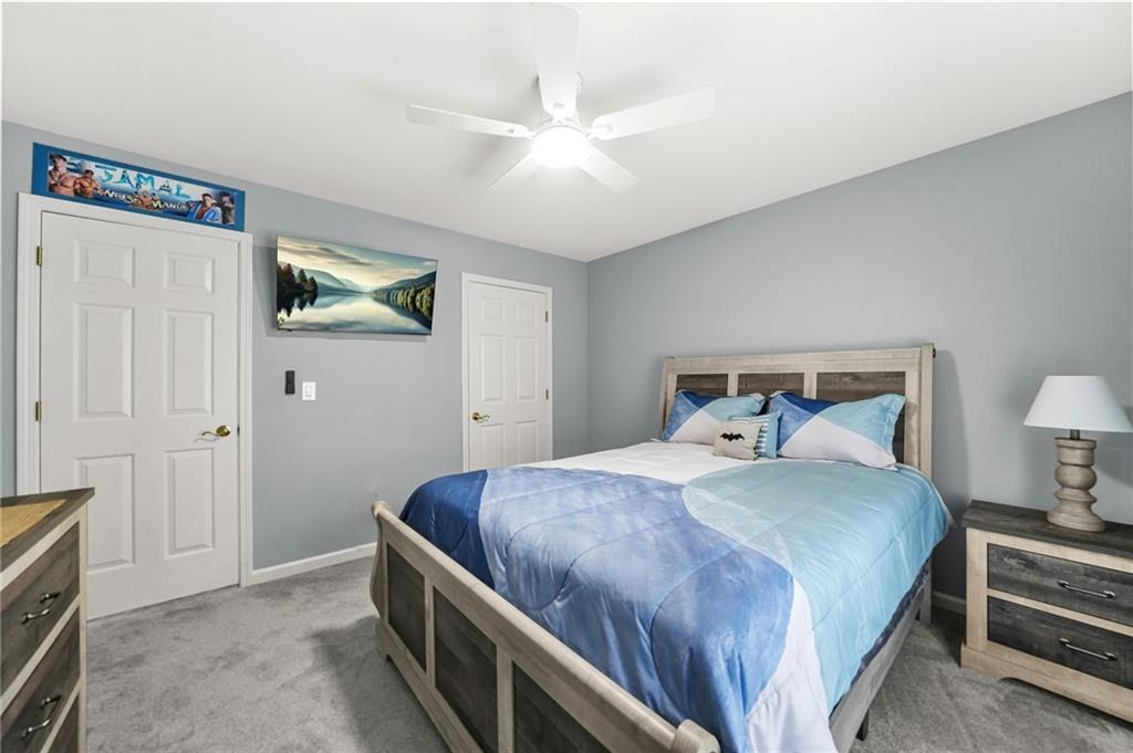1203 Big Tree Pointe Villa Rica, GA 30180 - Photo 37 of 42 a bedroom with a bed and a chandelier