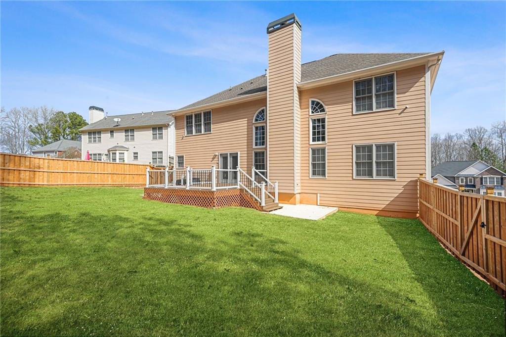 1203 Big Tree Pointe Villa Rica, GA 30180 - Photo 41 of 42 a view of a house with a backyard and a chair