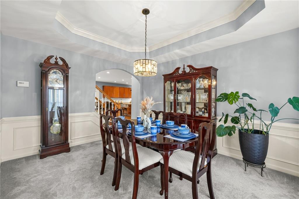 1203 Big Tree Pointe Villa Rica, GA 30180 - Photo 5 of 42 a dining room with furniture potted plants and a chandelier