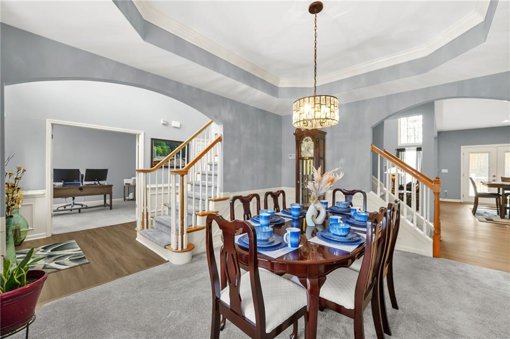 1203 Big Tree Pointe Villa Rica, GA 30180 - Photo 6 of 42 a view of a dining room and livingroom with furniture wooden floor a chandelier