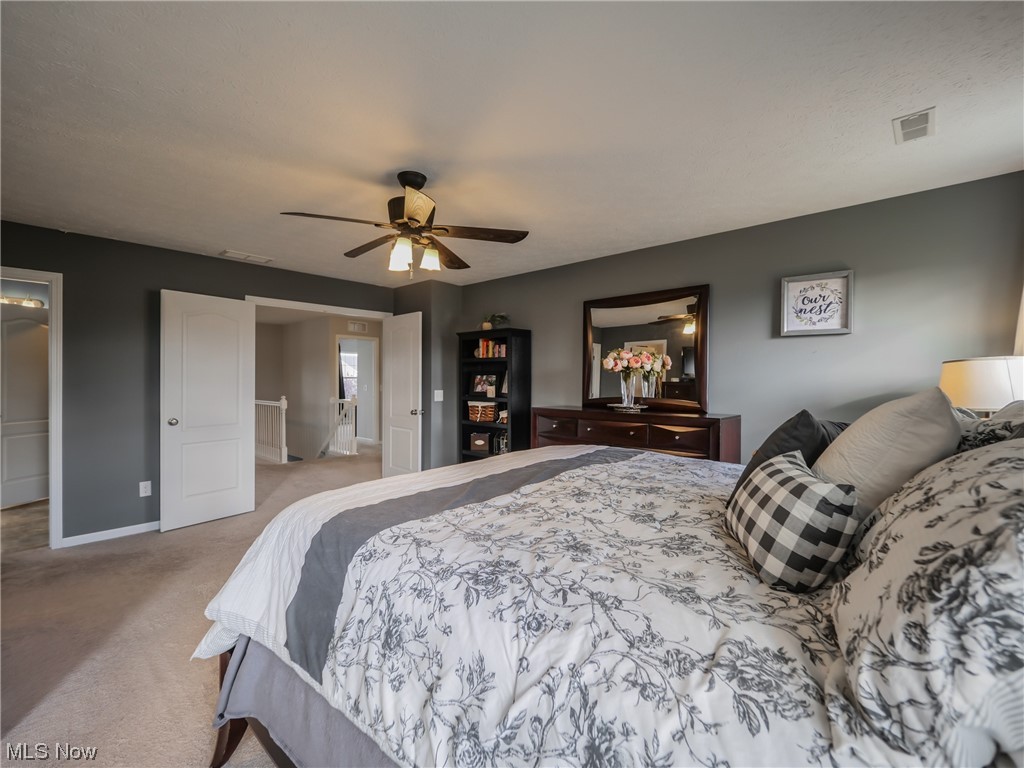 37571 Amber Way North Ridgeville, OH 44039 - Photo 18 of 35 Bedroom with connected bathroom, light carpet, and ceiling fan
