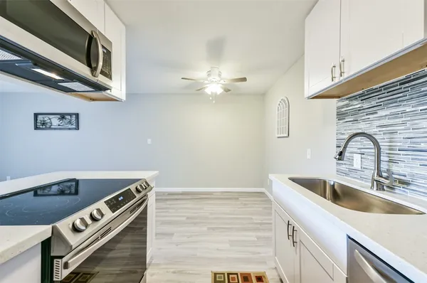 a kitchen that has a sink and a stove