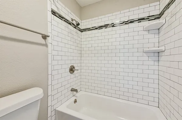 a bathroom with a shower and a toilet